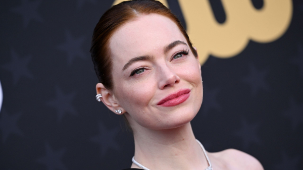 Emma Stone wears a black gown and diamonds to an awards show.